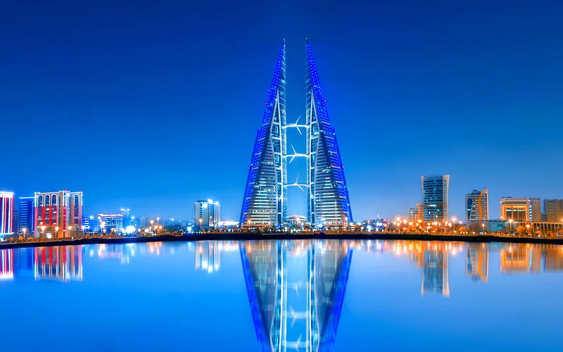 Stunning night view of Bahrain World Trade Center with clear water reflections and modern skyline