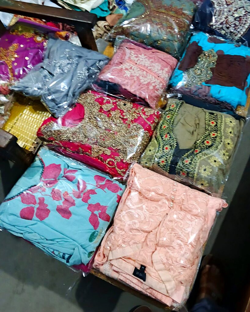 New embroidered women’s suits, packed and ready for distribution by PHWO in Larkana