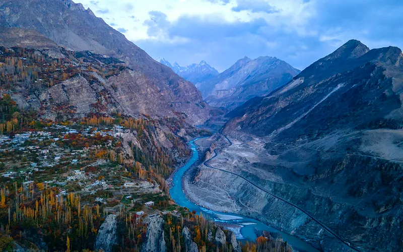 Stunning aerial view of the Hunza Valley with autumn foliage and a winding river in Pakistan, Gilgit-Baltistan