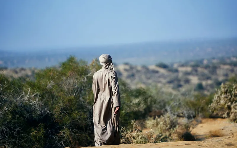 A person in traditional attire explores the countryside of Ghotki, Sindh, Pakistan