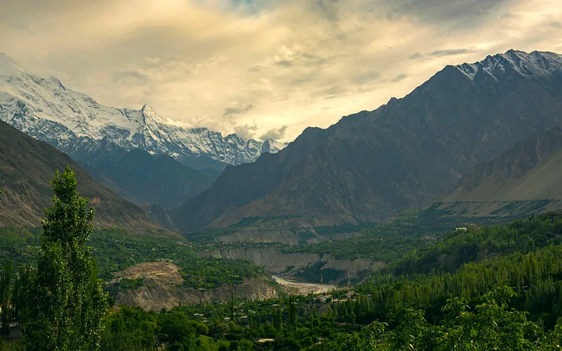 Breathtaking view of Hunza Valley with lush greenery and snow-capped peaks
