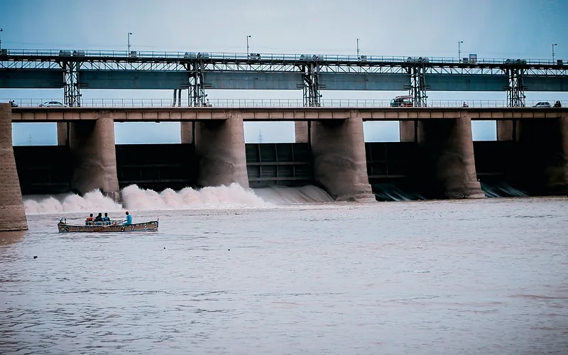 Hydroelectric dam in Jamshoro, Sindh with boat and people on Indus River