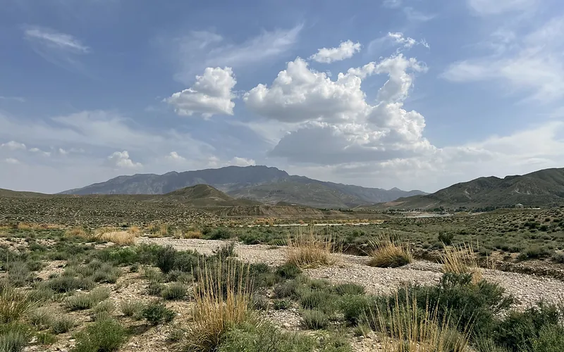 Expansive view of the arid and mountainous terrain near Quetta, Balochistan. The sunlit scenery highlights natural beauty, Balochistan