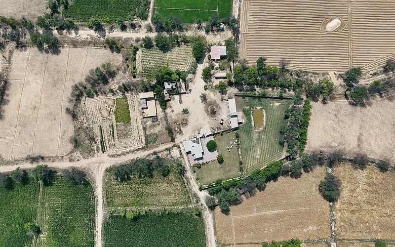 An aerial perspective of lush green and dry fields in Punjab, Pakistan, Punjab