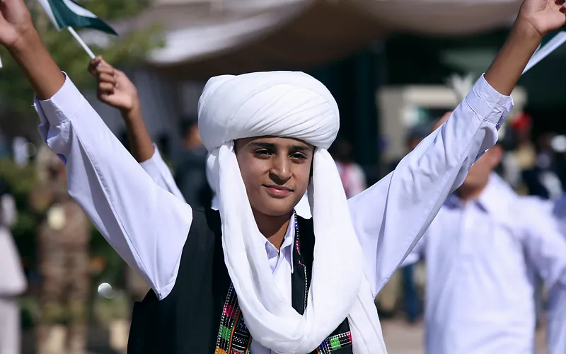 Teenage boy in traditional Baloch attire celebrates a cultural festival in Pakistan, Balochistan